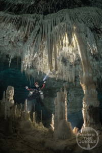 Cave Diver observing overhead formations while cave diving