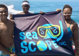 Youth Discoverers posing with Sea Scopes Inc Flag