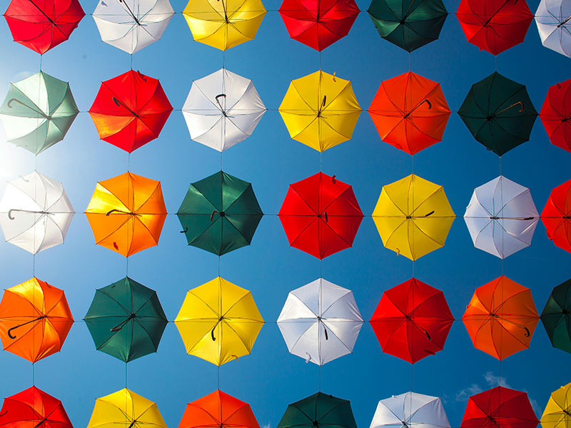 Collection of colorful umbrellas overhead.