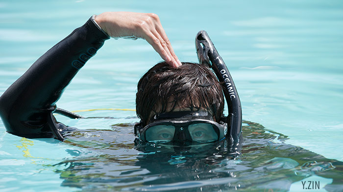 Diver Signaling "okay" with hand on head