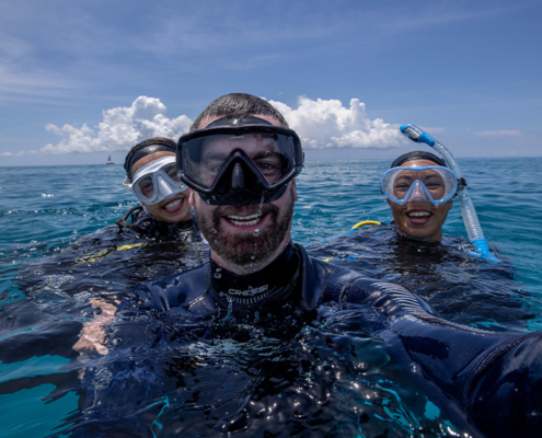 Divers smiling on surface of water