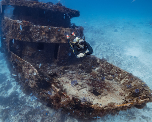 Diver floating over shipwreck